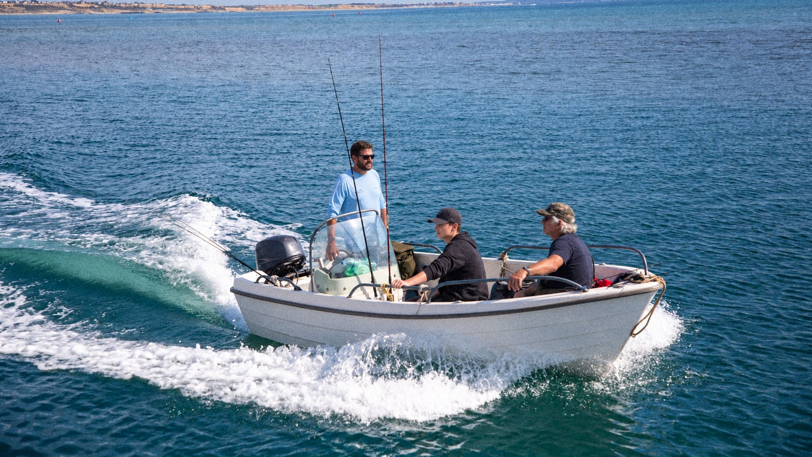 Anglers fishing from a small boat off the English coast