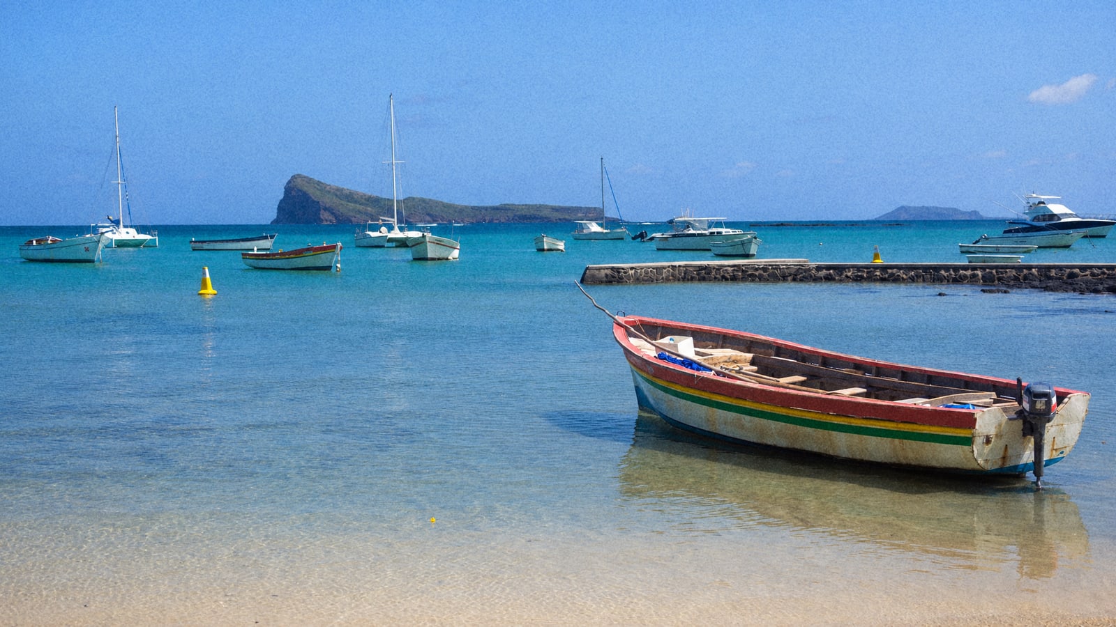 Anglers trolling off the north coast of Mauritius with Coin de Mire island behind the boat