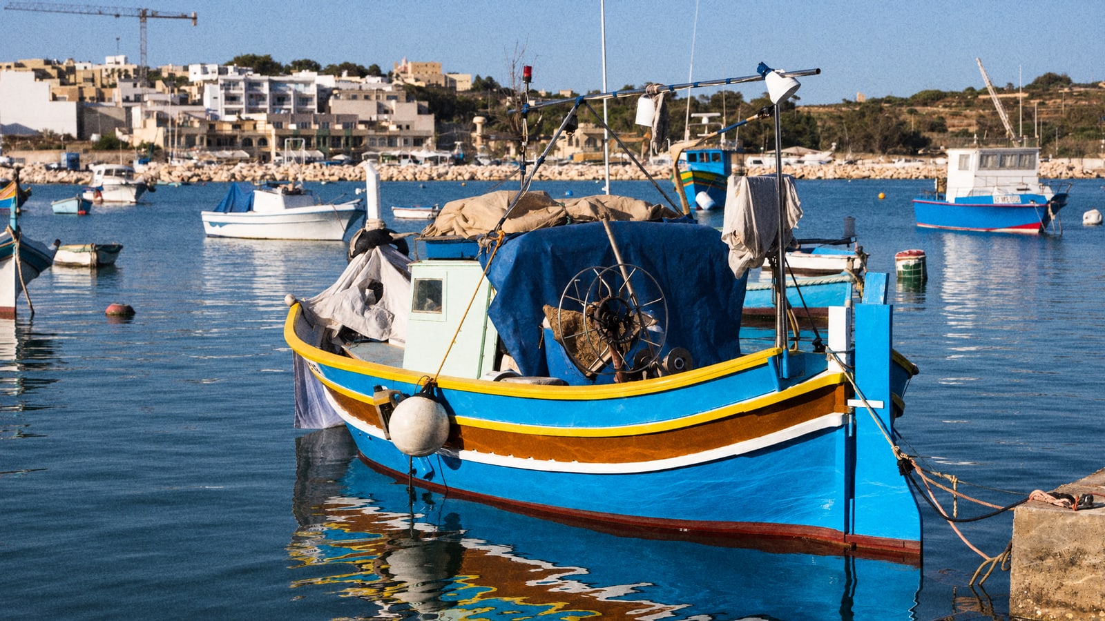 A traditional Maltese luzzu moored in Marsaxlokk harbour