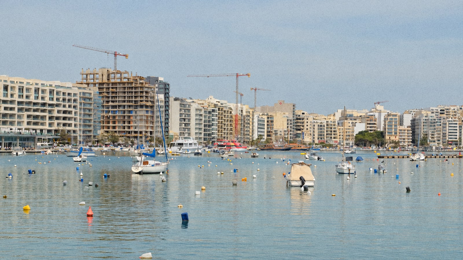 Boats moored in Sliema Creek with the Gzira seafront behind, where Malta's fishing charters leave from