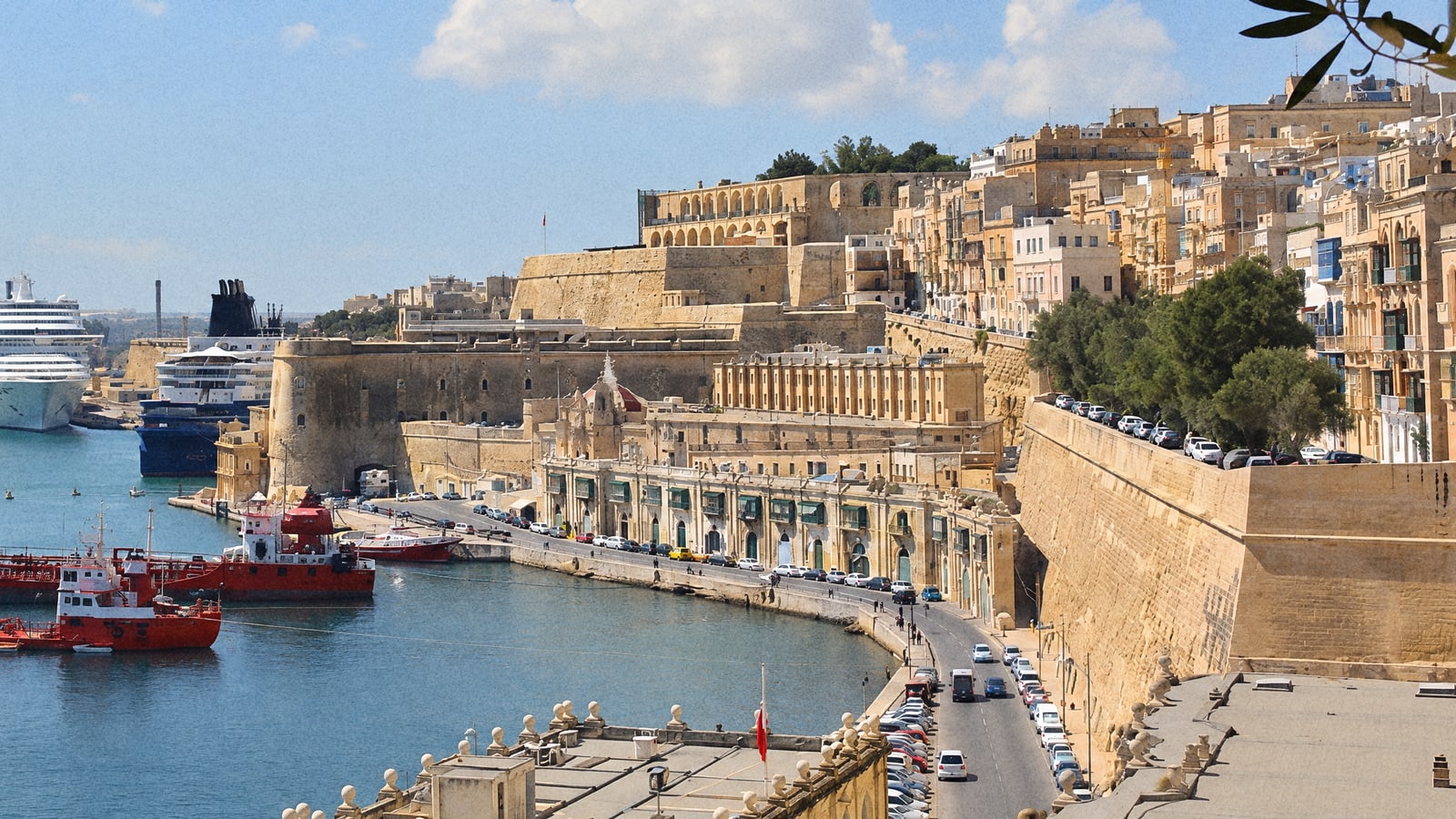 A cruise ship berthed in the Grand Harbour below the walls of Valletta, Malta