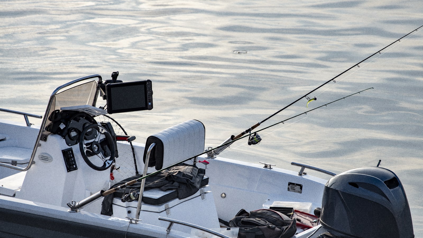 A small sportfishing boat with rods set in the holders, ready for a morning trip off Mauritius