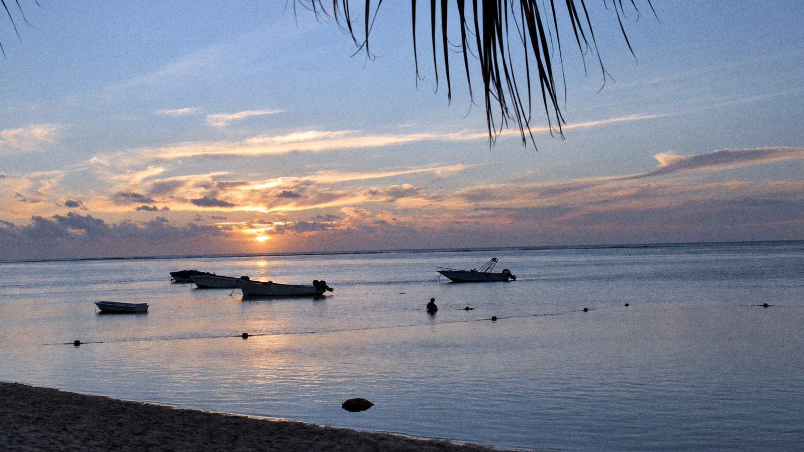 Fishing boats at anchor off the west coast of Mauritius at sunset